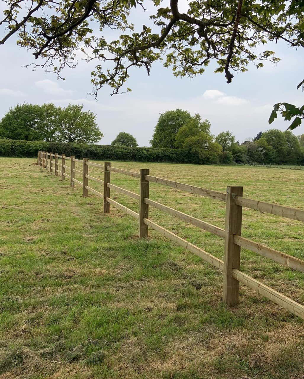 This is a photo of a post and rail fence installed in a field by Fast Fix Fencing Caterham